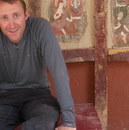 Alex hides in the shade near some wall paintings