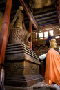 Buddha statue with stupa behind it